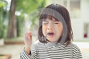 Portrait of Asian crying little girl with little rolling tears weeping emotion, hurt in pain fit drops cheek. Young crying panic
