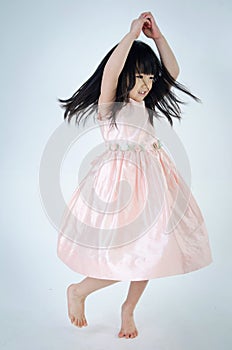 Portrait of asian cute gril is dancing photo