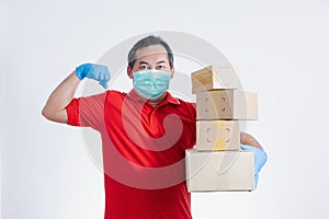 Portrait of Asian delivery man with face medical mask in red cloth holding a box package.