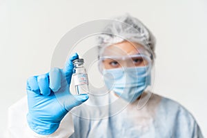 Portrait of asian doctor or nurse in personal protective equipment, female healthcare worker showing covid-19 vaccine