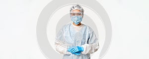 Portrait of asian doctor or nurse in ppe, personal protective equipment, standing in confident, ready pose, white