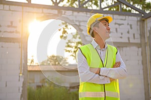 Portrait of An Asian Engineering man wearing safety helmet checking construction site analyzing about project progress