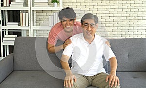 Portrait Asian family happy smiling senior father and grown-up son at home