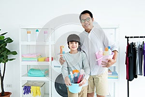 Portrait of asian father and son hand hold cleaning household equipment