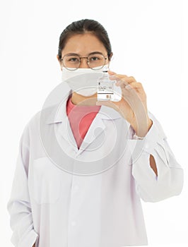 Portrait of Asian female doctor in white gown coat wearing eyes glasses in white background holding bottle of coronavirus covid 19