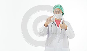 Portrait of Asian female doctor in white gown coat wearing eyes glasses in white background holding bottle of coronavirus covid 19