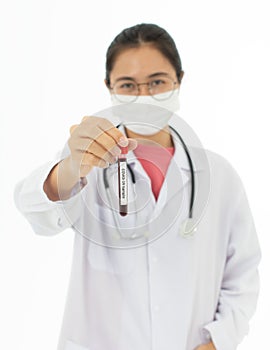 Portrait of Asian female doctor in white gown coat wearing eyes glasses in white background holding test tube of coronavirus covid