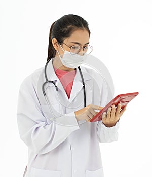 Portrait of Asian female doctor in white gown coat wearing protective hygiene mask and holding a tablet computer in hand. Isolated