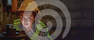 Portrait of asian female mechanic engineer working with steel drilling machine in metal work manufacturing factory