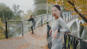 Portrait of the Asian Female Runner Enjoying Outside. Jogger Woman After Running Resting in the Autumn Park While Her