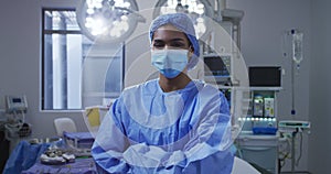 Portrait of asian female surgeon wearing face mask standing in hospital operating theatre