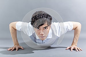 Portrait of  asian  fitness man doing push ups