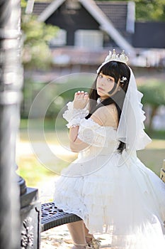 Portrait of asian girl in lolita fashion dress in garden background