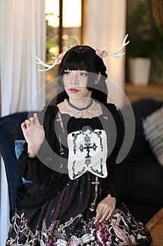 Portrait of asian girl in lolita fashion dress in vintage garden background