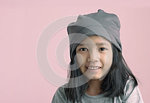 Portrait asian gril happiness and smiling on pink background with copy space