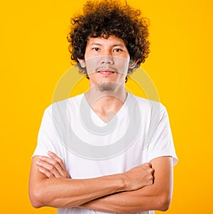 Portrait of Asian handsome man with curly hair with arms crossed