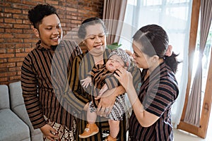 Portrait of asian happy family wearing javanese batik heritage