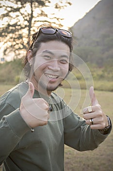 Portrait of asian hipster man toothy smiling face with happiness