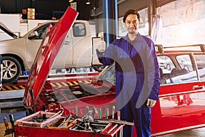 Portrait Asian Japanese male mechanic worker portrait in auto service workshop car maintenance center replace fix auto engine part