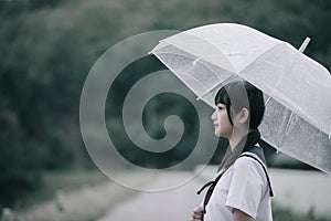 Portrait of asian japanese school girl costume with umbrella