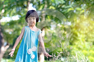 Portrait Asian kid girl aged 4 to 6 years old, cute face, short hair, wearing a green skirt, fashion style, bright face with a