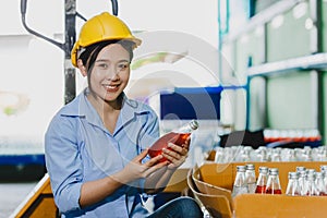 Portrait Asian lady products quality check staff worker smile with drink product test before shipping