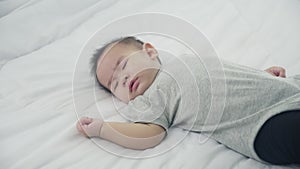 Portrait of asian little baby girl sleeping on bed in the bedroom at home.