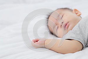 Portrait of asian little baby girl sleeping on bed in the bedroom at home.