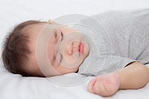 Portrait of asian little baby girl sleeping on bed in the bedroom at home, newborn napping with cozy and relax.