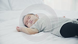 Portrait of asian little baby girl sleeping on bed in the bedroom at home, newborn napping with cozy and relax.