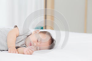 Portrait of asian little baby girl sleeping on bed in the bedroom at home, newborn napping with cozy and relax.