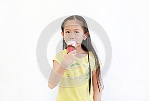 Portrait asian little child girl eating ice cream cone isolated on white background