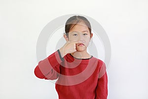 Portrait Asian little child with holding forefinger close his nose while smelling something intolerable smell  holding breath with