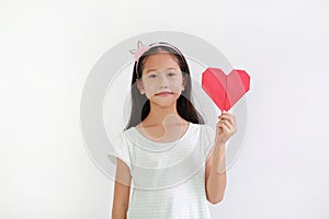 Portrait of Asian little girl child holding red heart sign on white background