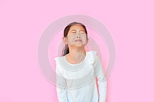 Portrait asian little girl crying isolated on pink background. Angry kid with sad expressions and screaming