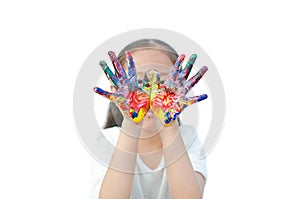 Portrait of Asian little girl with looking through her colorful hand painted in front of her eye. Focus at baby hands