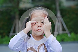 Portrait of asian little girl was crying in park outdoor