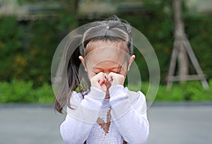 Portrait of asian little girl was crying in park outdoor