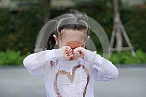 Portrait of asian little girl was crying in park outdoor