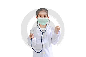 Portrait asian little kid girl showing stethoscope and hand fight while wearing doctor`s uniform and medical mask isolated on