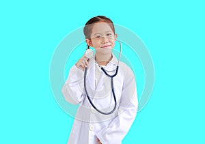 Portrait asian little kid girl with stethoscope while wearing doctor`s uniform isolated over cyan background