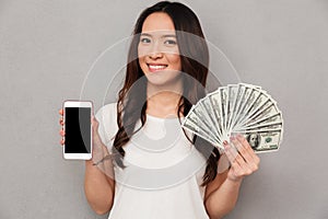 Portrait of asian lucky woman 20s holding fan of money dollar ba