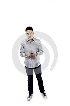 Asian male using a mobile phone on studio