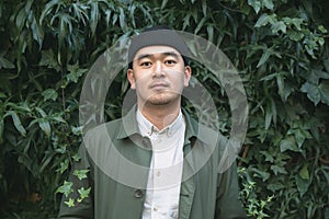 Portrait of asian man against ivi clad background