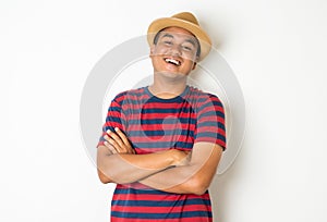 Portrait of an Asian man aged 27-35 who is currently enjoying Exhilarating And stood to cross his arms to express joy and