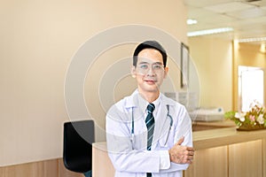 Portrait of asian man doctor wearing glasses with stethoscope while standing in the hospital