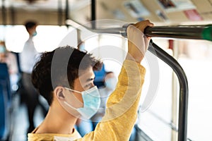 Portrait of asian man in facemask standing in bus