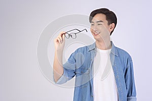 Portrait of asian man wearing glasses over white background studio, eyecare concept