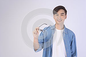 Portrait of asian man wearing glasses over white background studio, eyecare concept