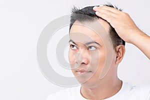 Portrait Asian man with worry feeling and touching on his head to show bald head or Glabrous problem. Studio shoot with copy space